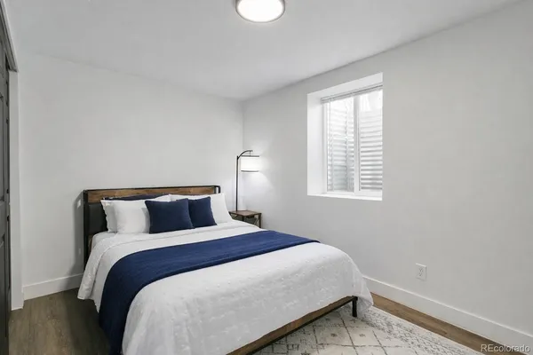 a bed sitting in a bedroom next to a window