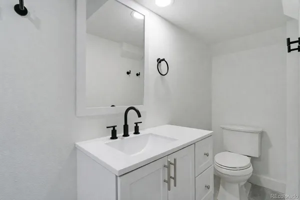 a bathroom with a sink toilet and mirror