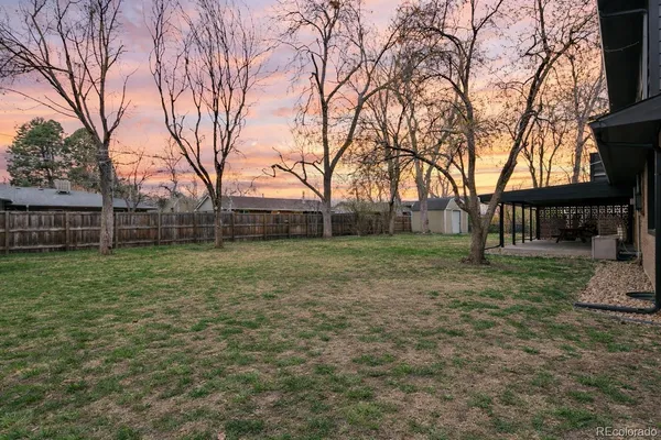 a view of a yard with a house in the background