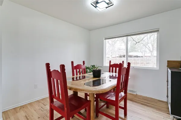 a view of a dining room with furniture and a window