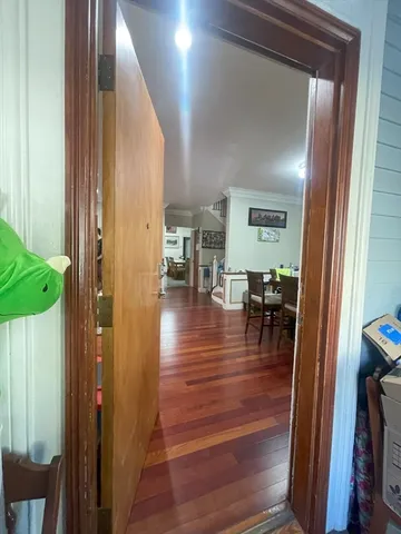 a view of a hallway and dining room with wooden floor