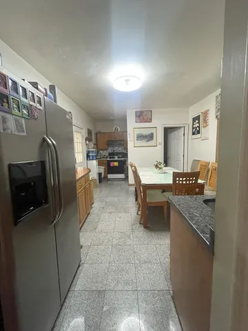 a kitchen with a stove a sink and a refrigerator