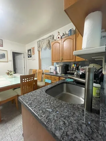 a kitchen view with cabinets and window