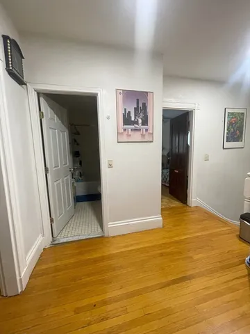 a view of a hallway to a livingroom and a couch