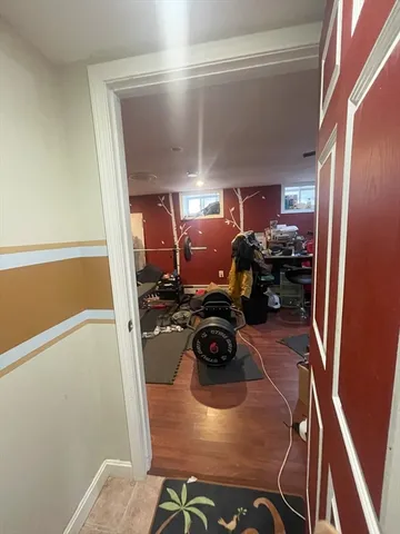 a room with water heater and a wooden floor