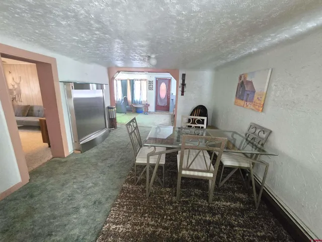 a view of a dining room with furniture and window