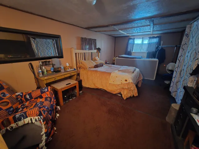 a bed room with a bed and a lamp