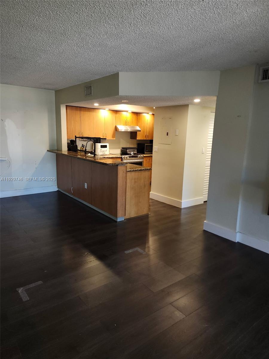 8540 Southwest 212th Street, Unit 303 Cutler Bay, FL 33189 - Photo 4 of 12 a view of open space with wooden floor