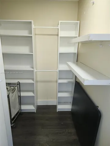 a view of walk in closet with empty racks