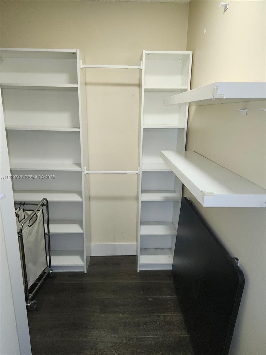 8540 Southwest 212th Street, Unit 303 Cutler Bay, FL 33189 - Photo 10 of 12 a view of walk in closet with empty racks