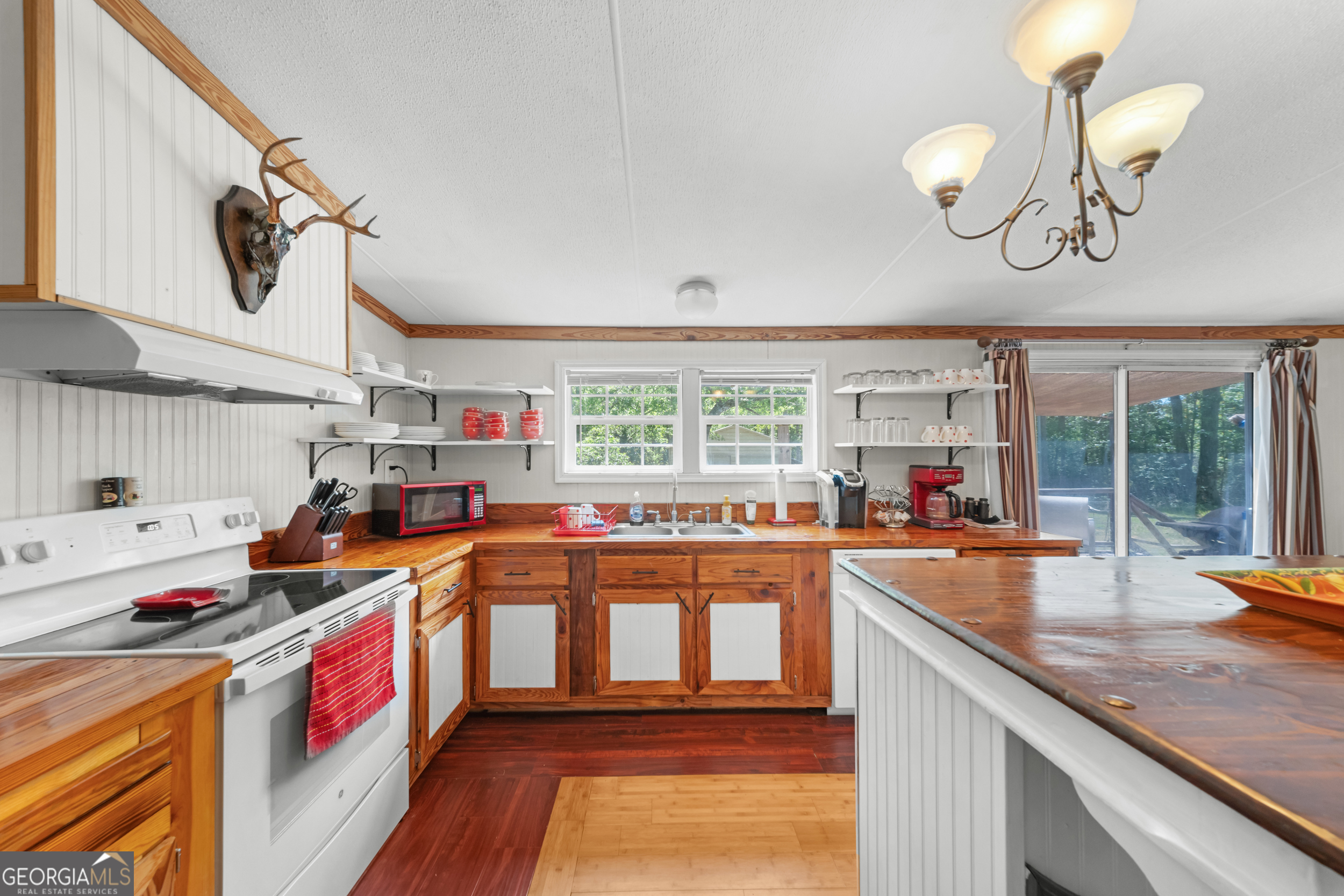 3347 Dickey Road Millen, GA 30442 - Photo 11 of 31 a kitchen with stainless steel appliances granite countertop a stove a sink and a microwave