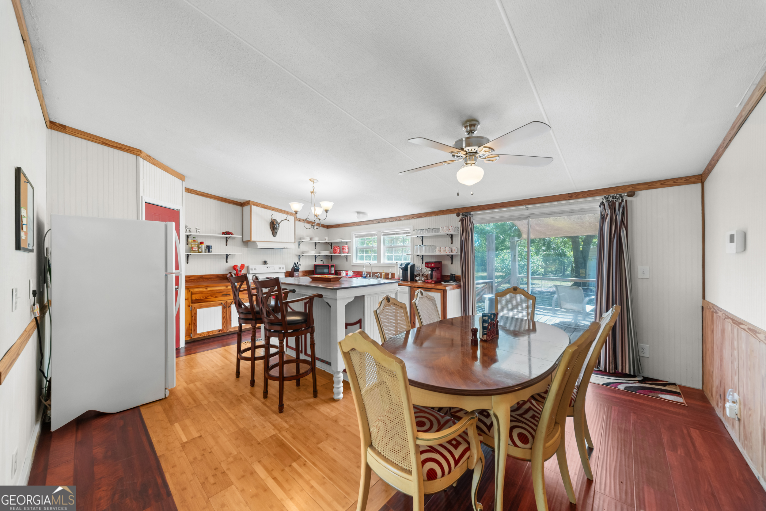 3347 Dickey Road Millen, GA 30442 - Photo 12 of 31 a dining room with furniture a chandelier and wooden floor