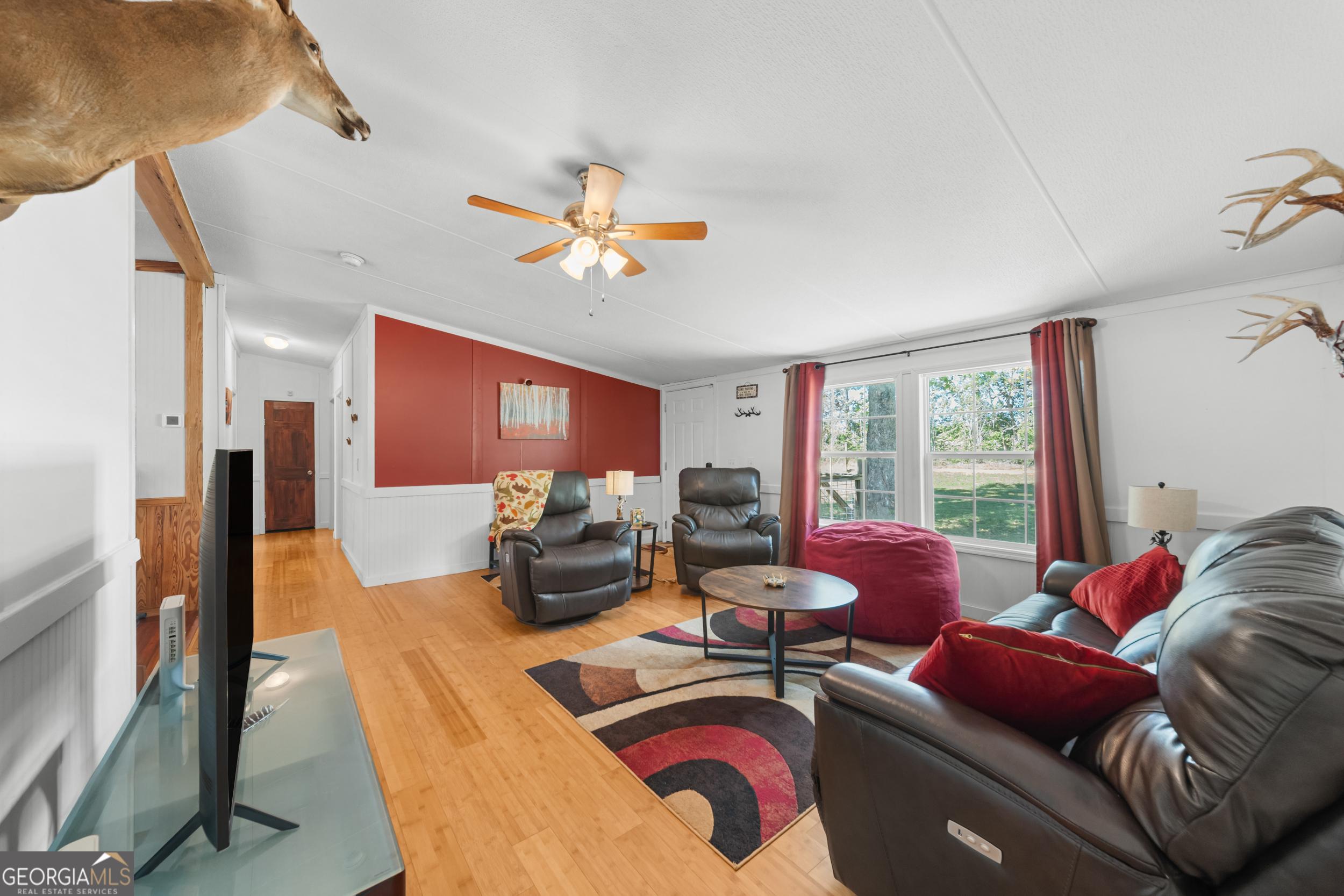 3347 Dickey Road Millen, GA 30442 - Photo 13 of 31 a living room with furniture fireplace and a large window