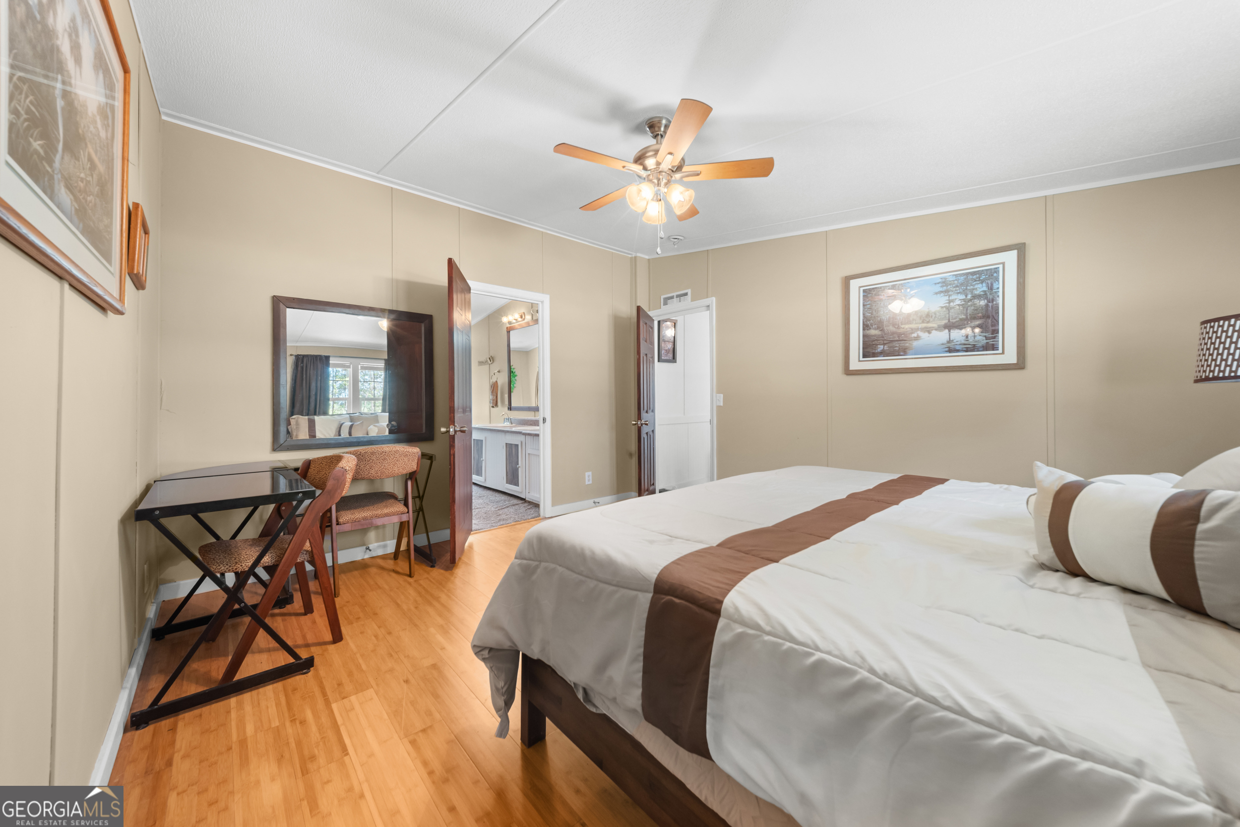 3347 Dickey Road Millen, GA 30442 - Photo 16 of 31 a bedroom with a bed and a chandelier