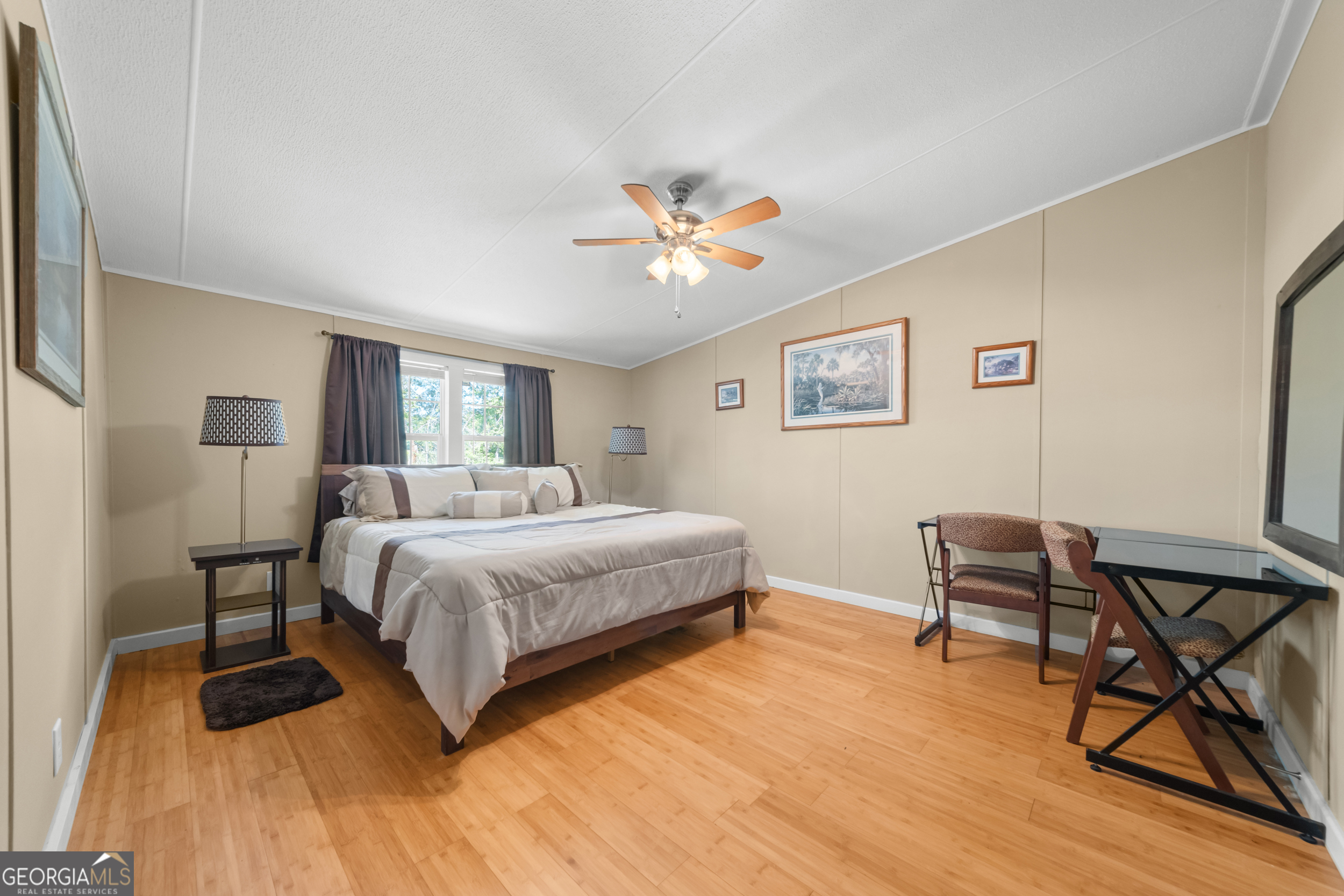 3347 Dickey Road Millen, GA 30442 - Photo 17 of 31 a spacious bedroom with a bed and a chair