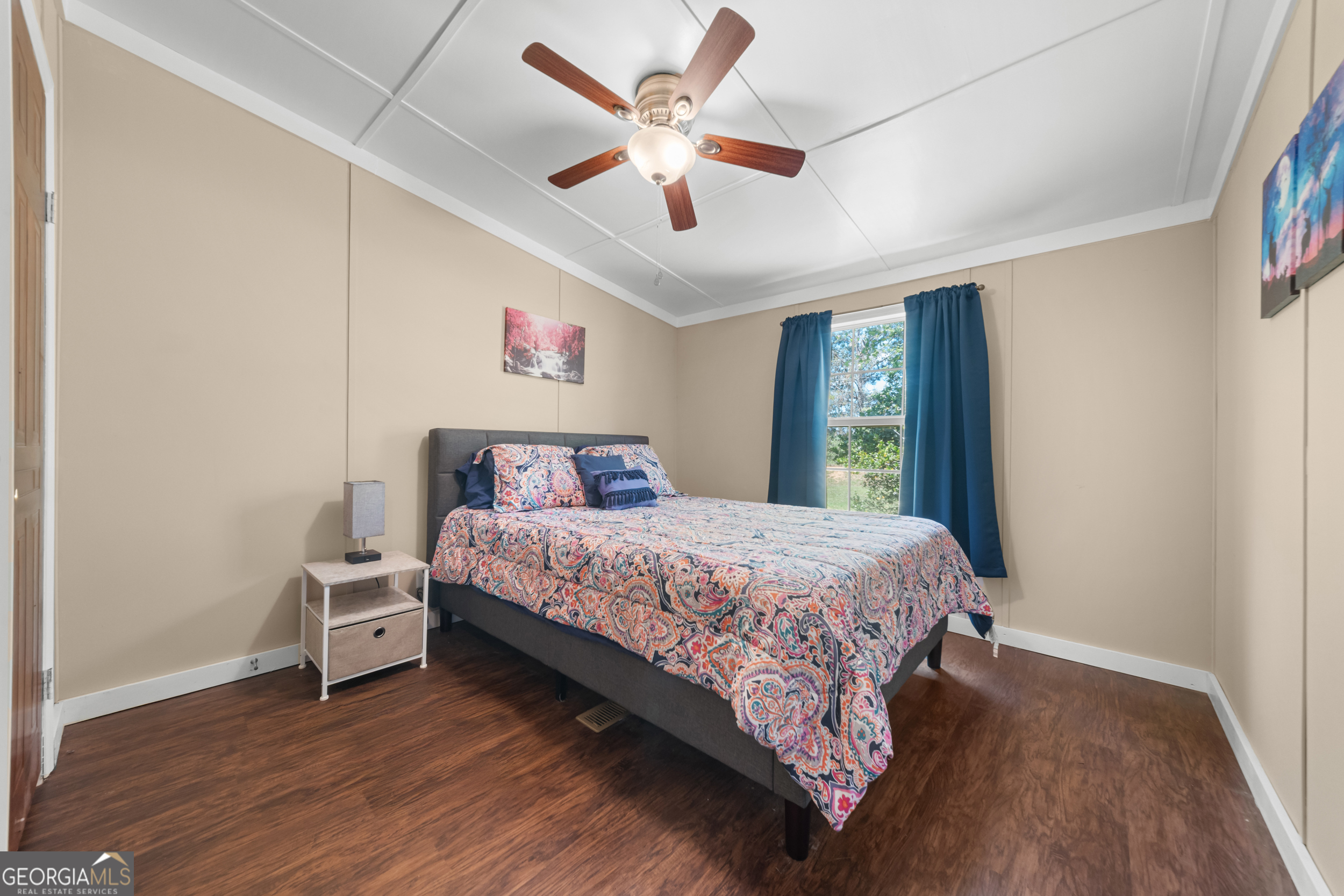 3347 Dickey Road Millen, GA 30442 - Photo 19 of 31 a bedroom with a large bed chandelier and a window