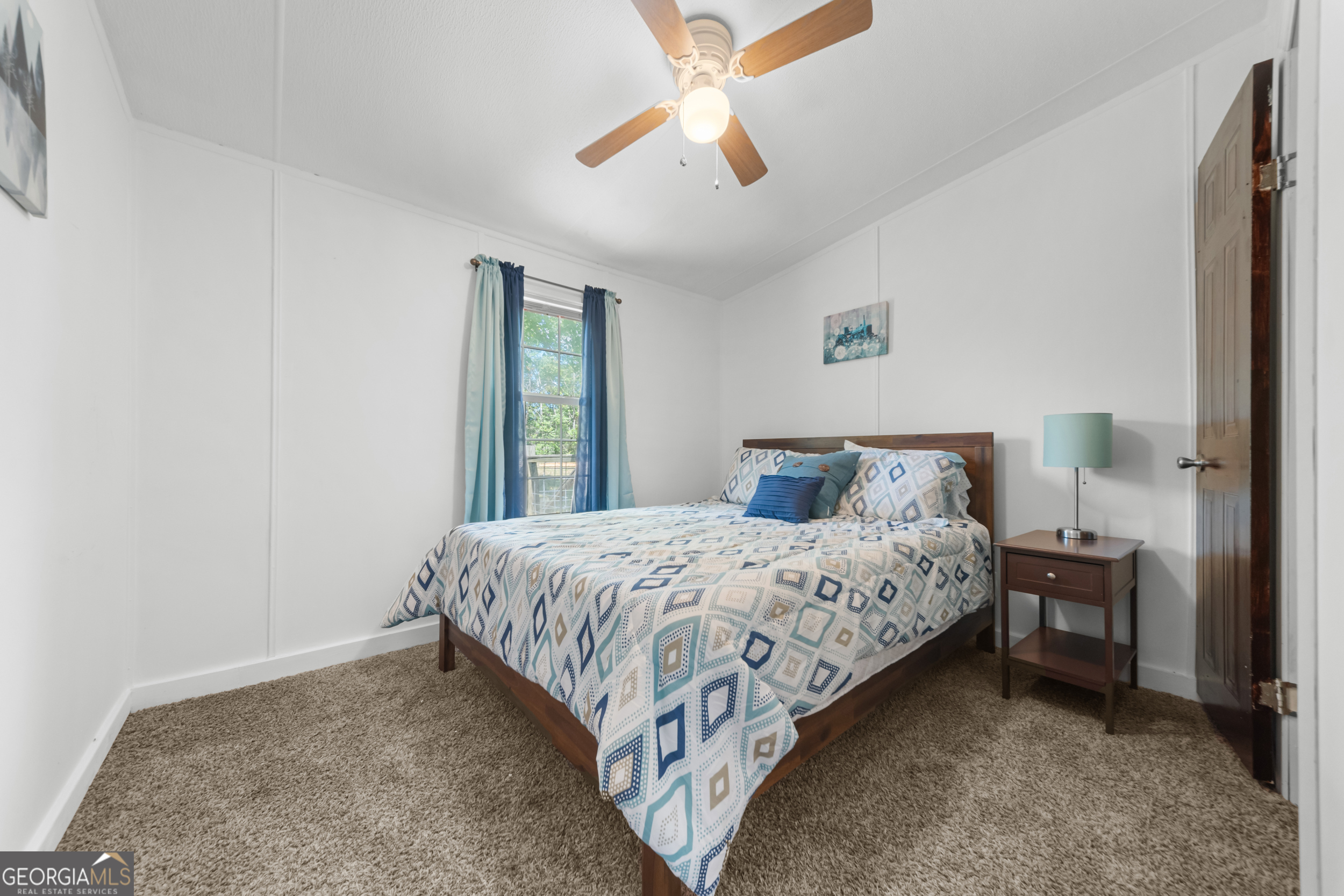 3347 Dickey Road Millen, GA 30442 - Photo 20 of 31 a bedroom with a bed and a chandelier