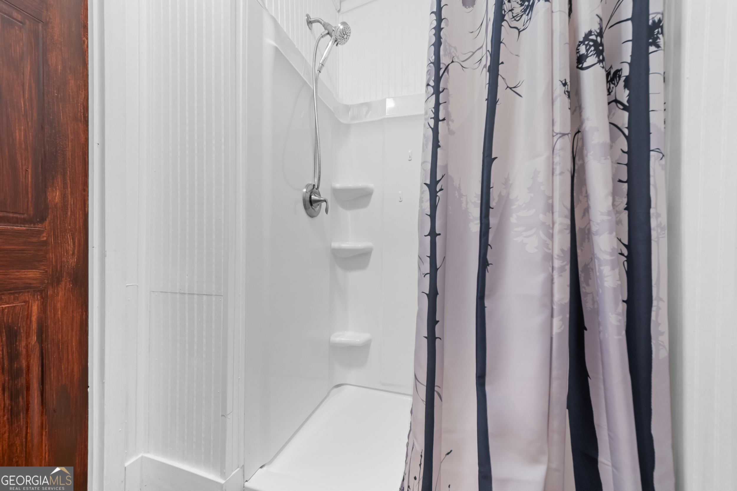 3347 Dickey Road Millen, GA 30442 - Photo 23 of 31 a bathroom with a glass shower door