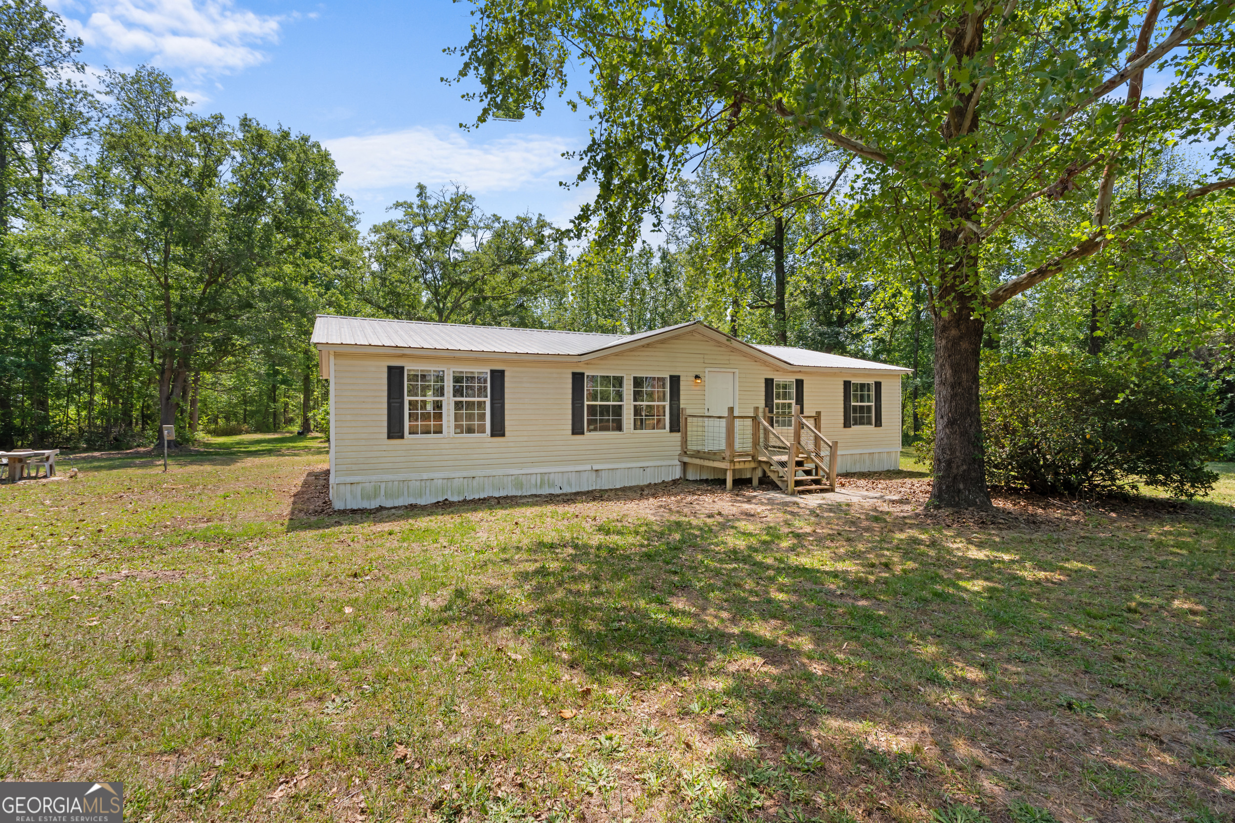 3347 Dickey Road Millen, GA 30442 - Photo 3 of 31 a front view of house with yard and trees in the background