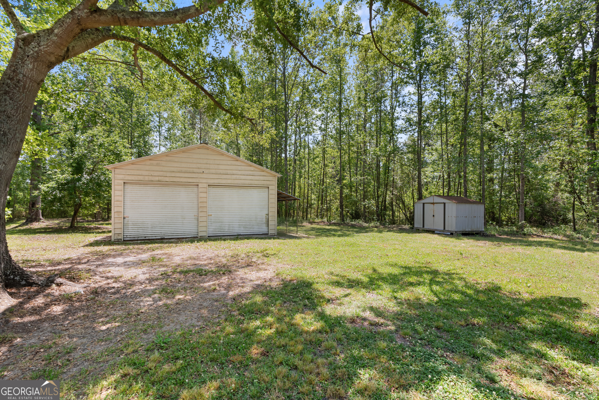 3347 Dickey Road Millen, GA 30442 - Photo 9 of 31 a front view of a house with a yard and a garage