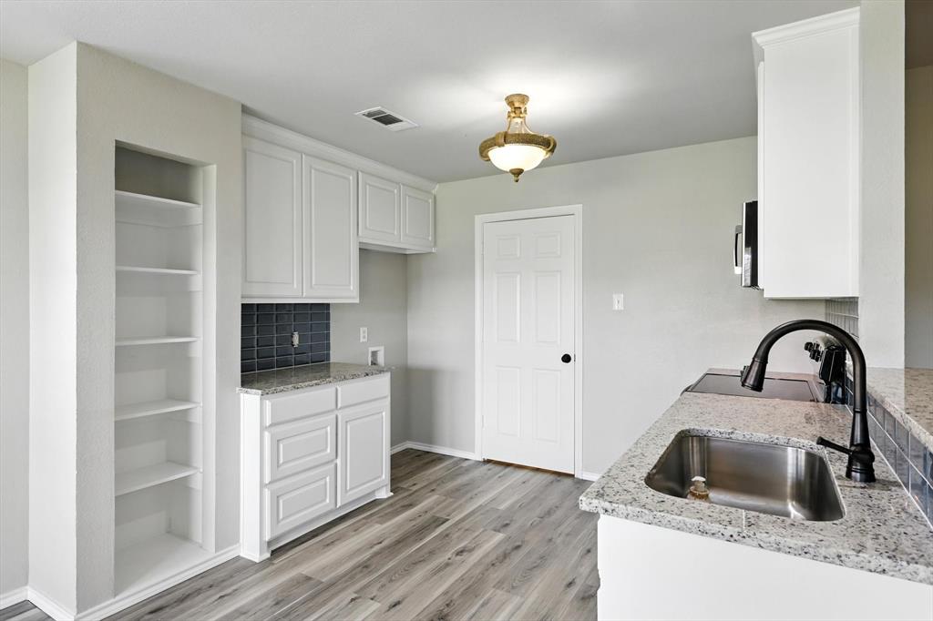 621 Torero Trail Oak Point, TX 75068 - Photo 13 of 34 a kitchen with a sink a stove and cabinets