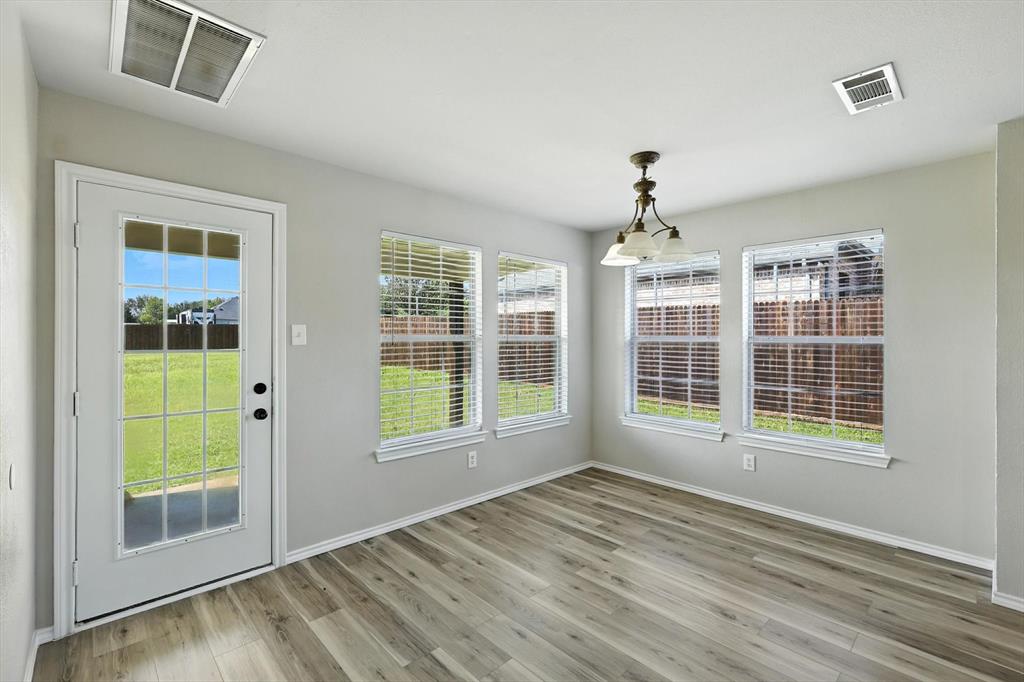 621 Torero Trail Oak Point, TX 75068 - Photo 16 of 34 an empty room with wooden floor and windows