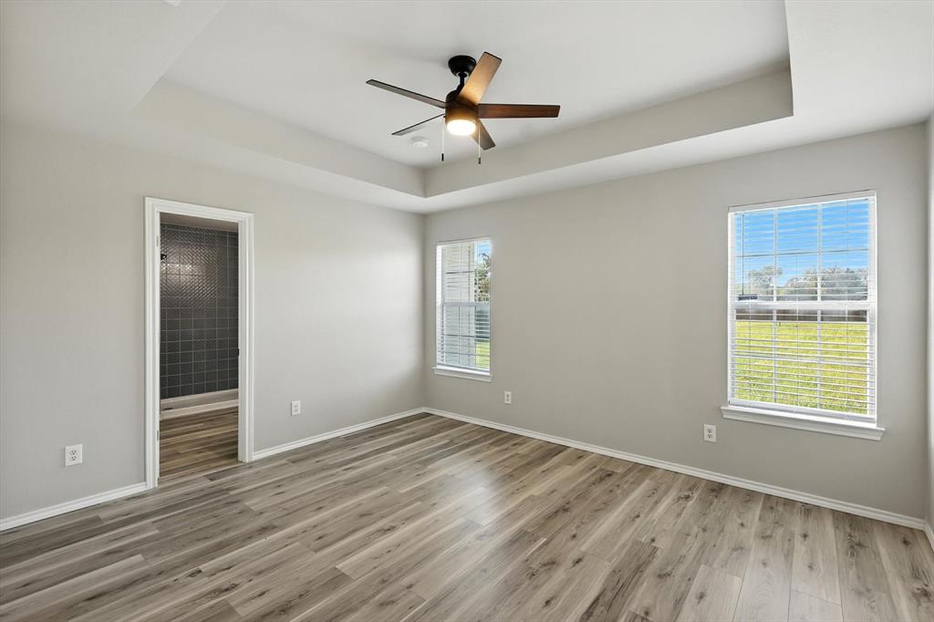 621 Torero Trail Oak Point, TX 75068 - Photo 18 of 34 a view of an empty room with wooden floor and a window