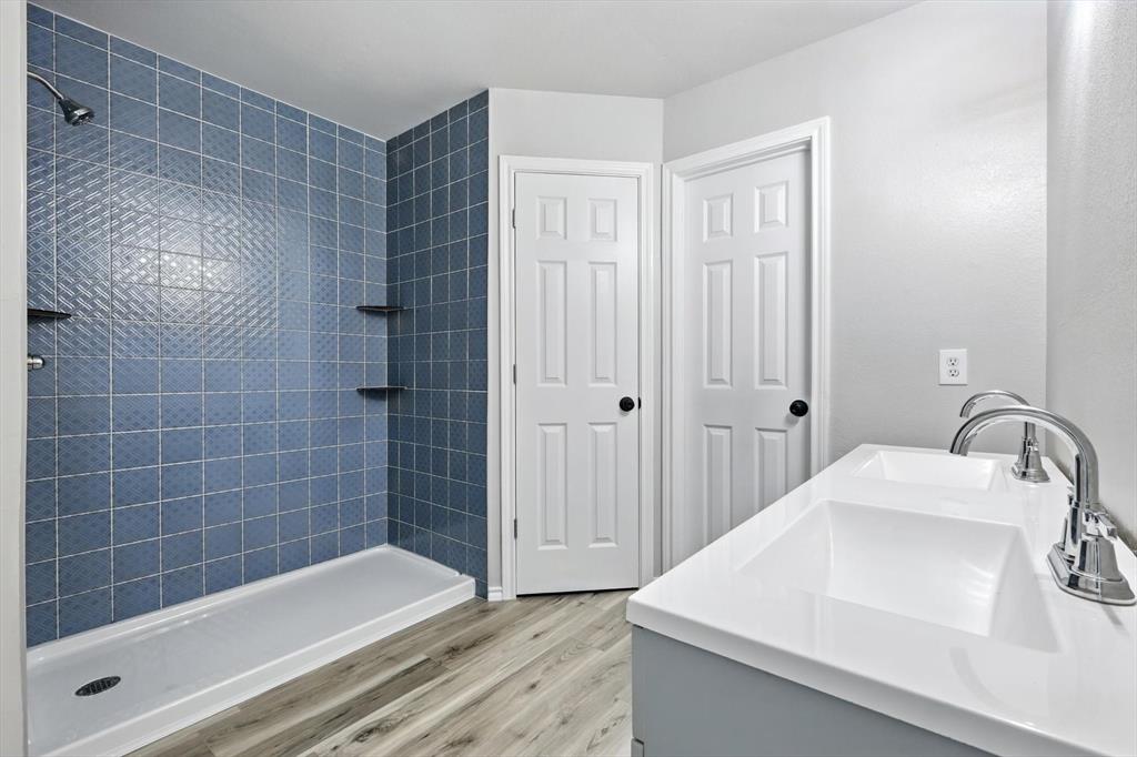 621 Torero Trail Oak Point, TX 75068 - Photo 20 of 34 a bathroom with a sink a toilet and shower