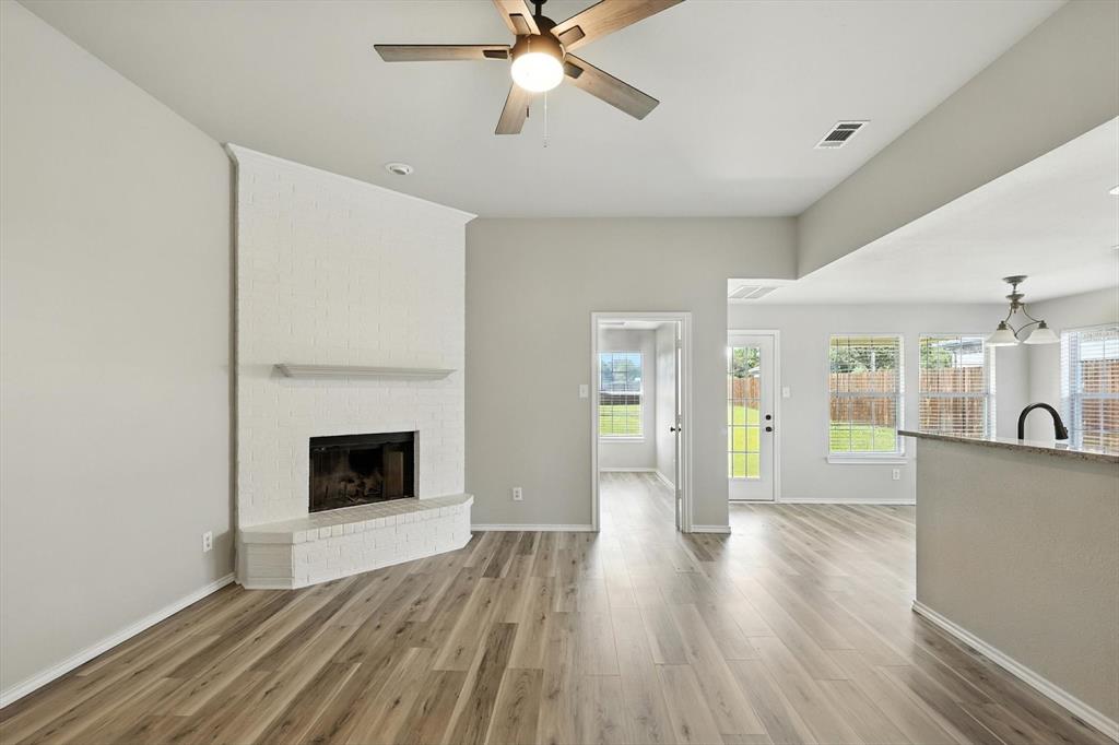 621 Torero Trail Oak Point, TX 75068 - Photo 7 of 34 a view of empty room with wooden floor and fireplace