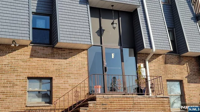 a view of a brick house with many windows