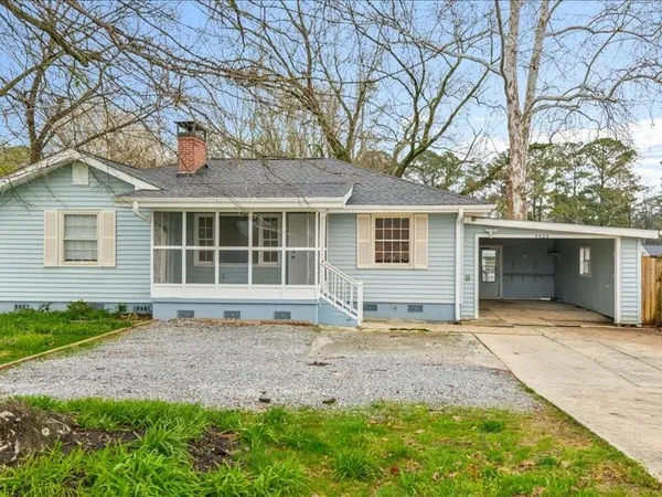 a front view of a house with a garden and yard