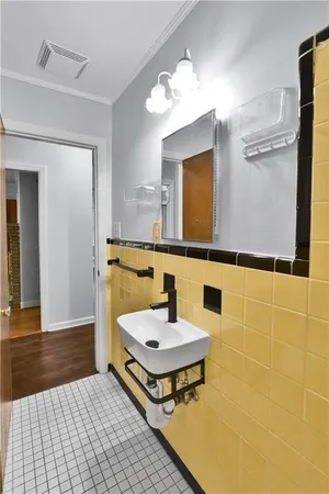 an empty room with wooden floor and closet area