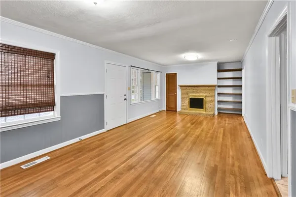 wooden floor in an empty room with a fireplace