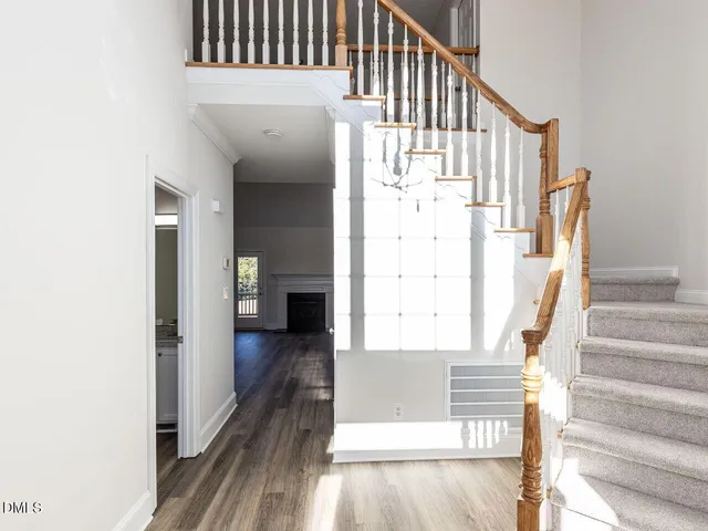 a view of staircase with white walls and railing