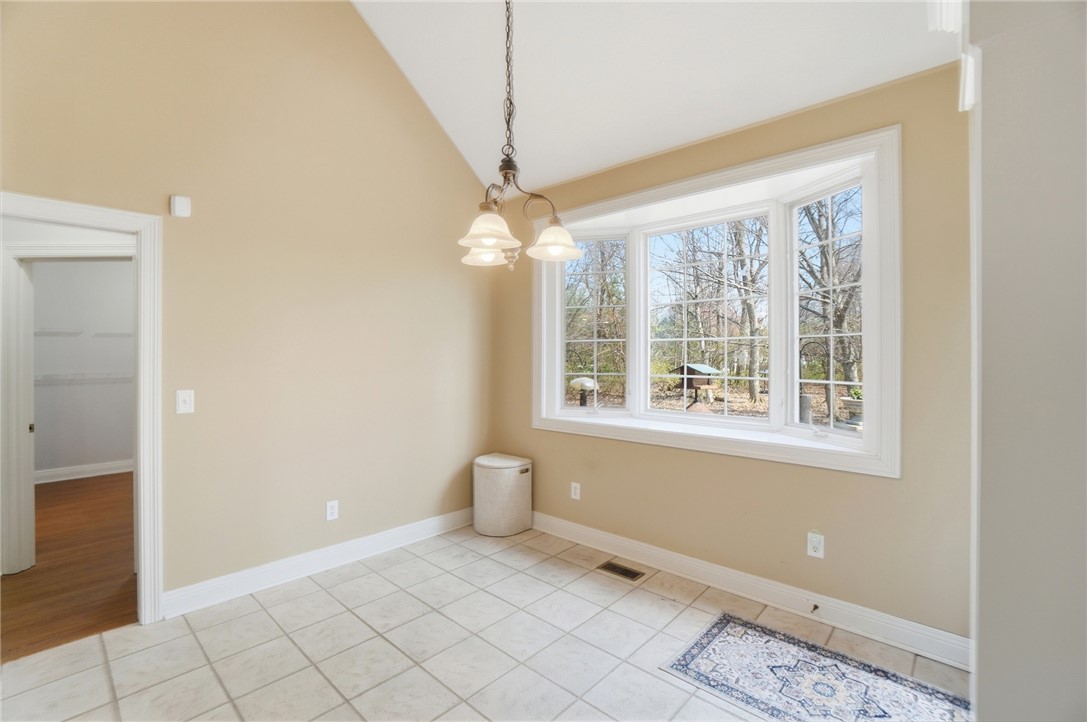 472 Timber Walk Court Springboro, OH 45066 - Photo 7 of 86 Bright dining area with tiled floors and a bay window framing serene outdoor views.