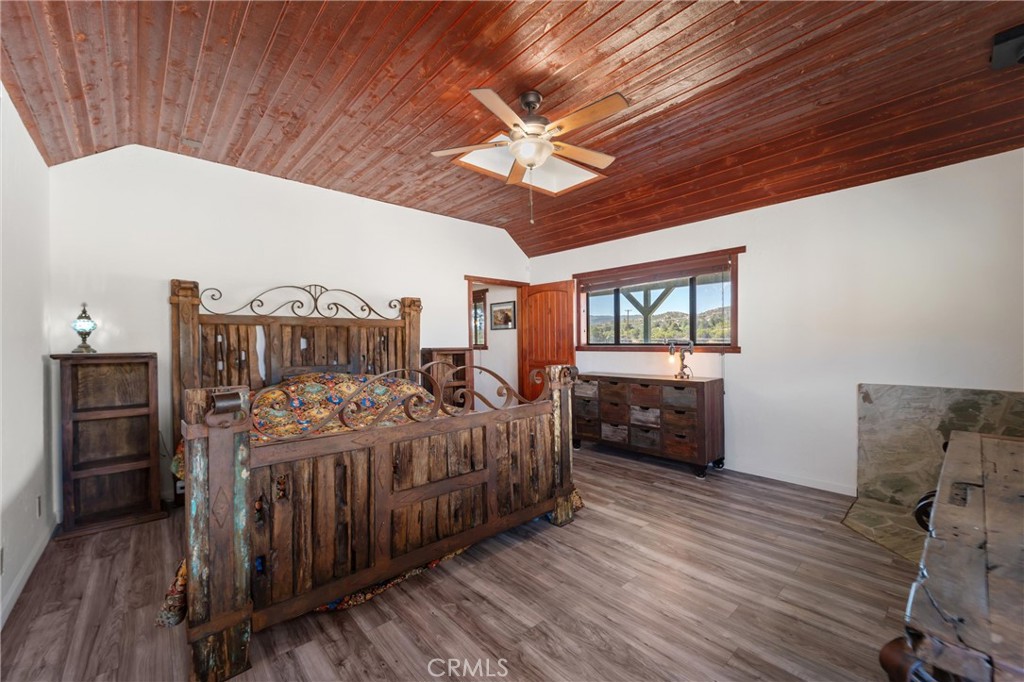 60861 Burnt Valley Road Anza, CA 92539 - Photo 29 of 66 a bedroom with a bed and wooden floor