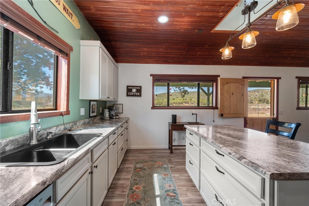 60861 Burnt Valley Road Anza, CA 92539 - Photo 5 of 66 a kitchen with a sink stove and cabinets