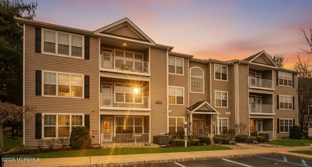 a front view of a residential apartment building with a yard