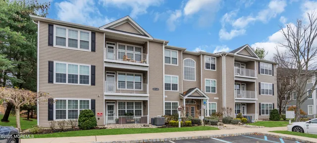 a front view of a residential apartment building with a yard