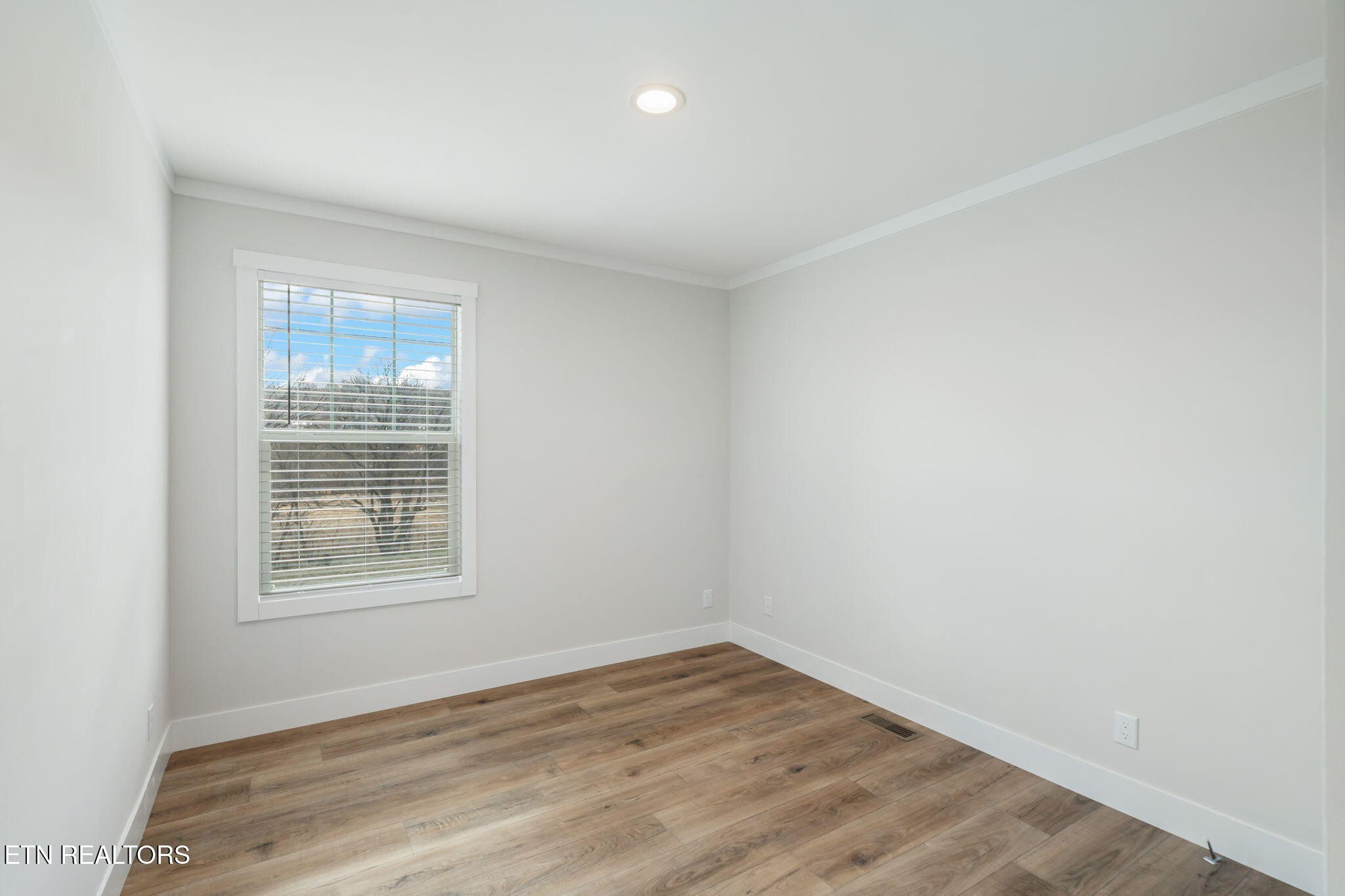 132 Cedarock Lane Rutledge, TN 37861 - Photo 26 of 42 an empty room with wooden floor and windows