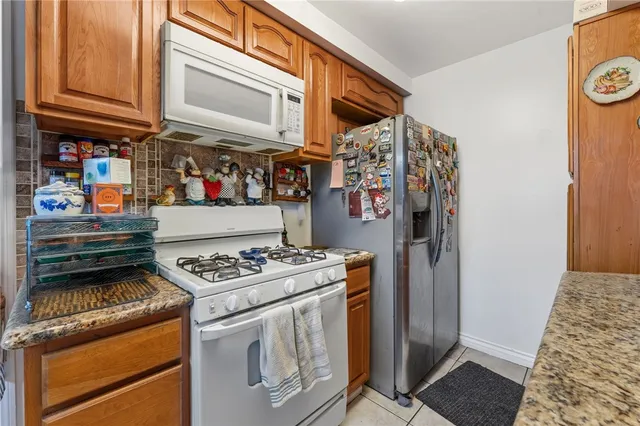 a kitchen with stainless steel appliances granite countertop a stove and a refrigerator