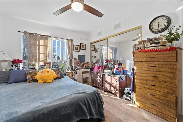 a bedroom with bed and a large window