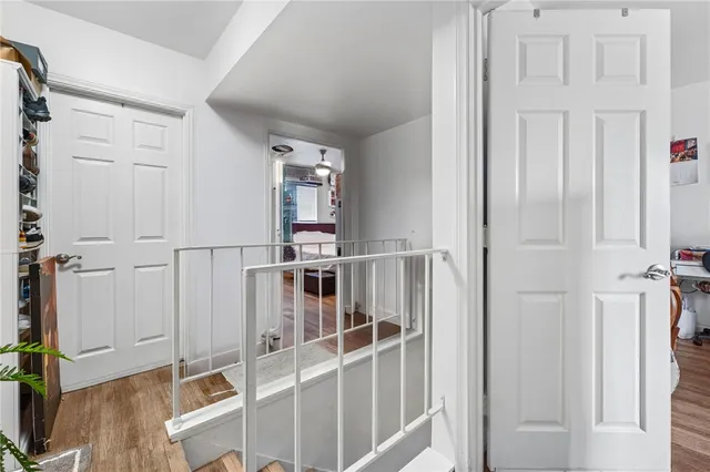 a view of a livingroom with wooden floor and white walls