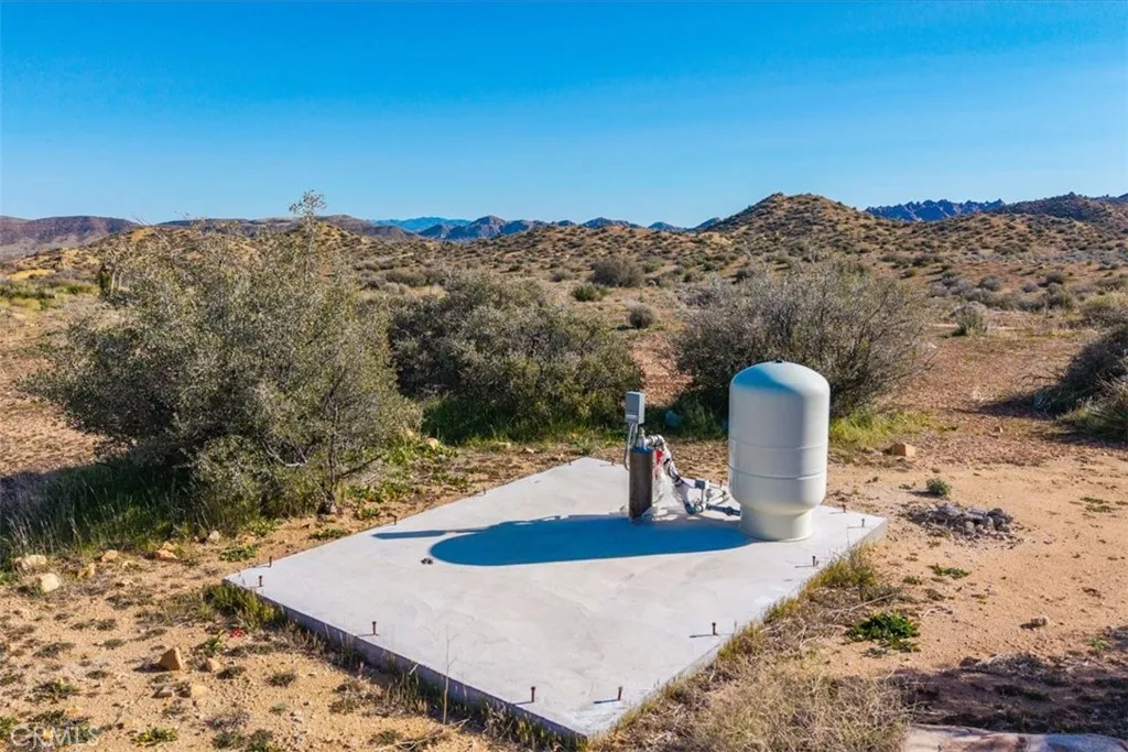 3263 Apache Pioneertown, CA 92268 - Photo 3 of 24 a view of a backyard with a table and chair
