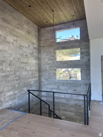 1918 Chimney Rock Road Heber City, UT 84032 - Photo 46 of 74 Stone accent wall with a contemporary chandelier, wood-finish ceiling, and multiple transom windows