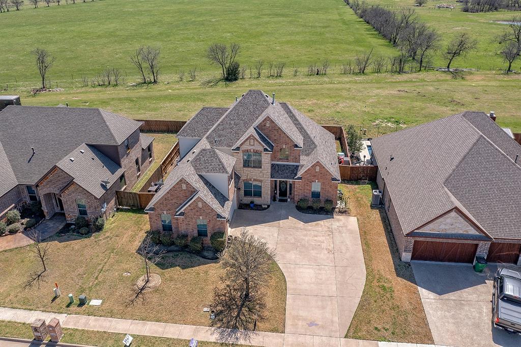 721 La Paloma Road Sanger, TX 76266 - Photo 1 of 1 an aerial view of a house with big yard and large trees