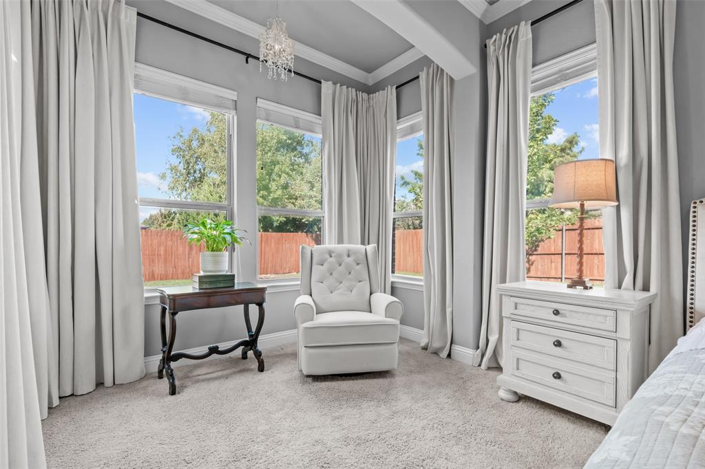 417 Prairie Run Aledo, TX 76008 - Photo 18 of 40 Sitting area in primary bedroom is equipped with beautiful window treatments and a chandelier.