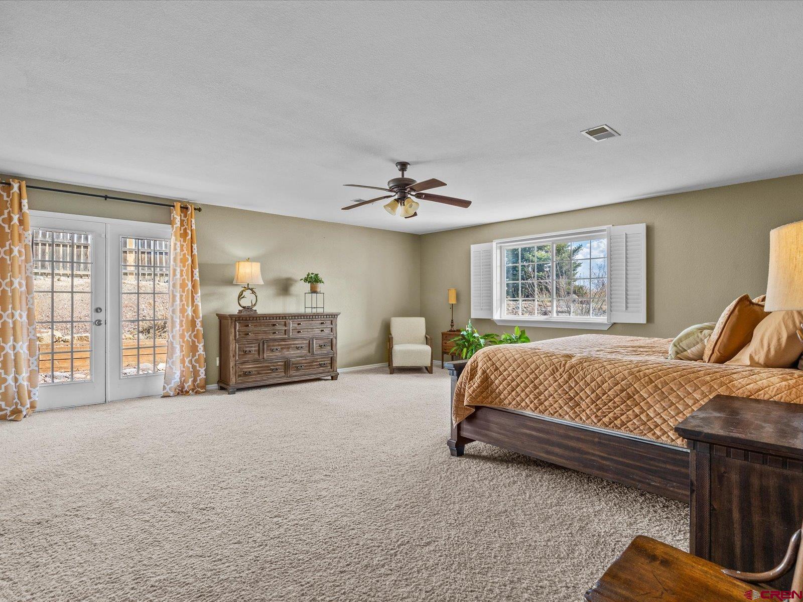 16222 6830th Road Montrose, CO 81401 - Photo 13 of 34 a spacious bedroom with a bed dresser and a large window