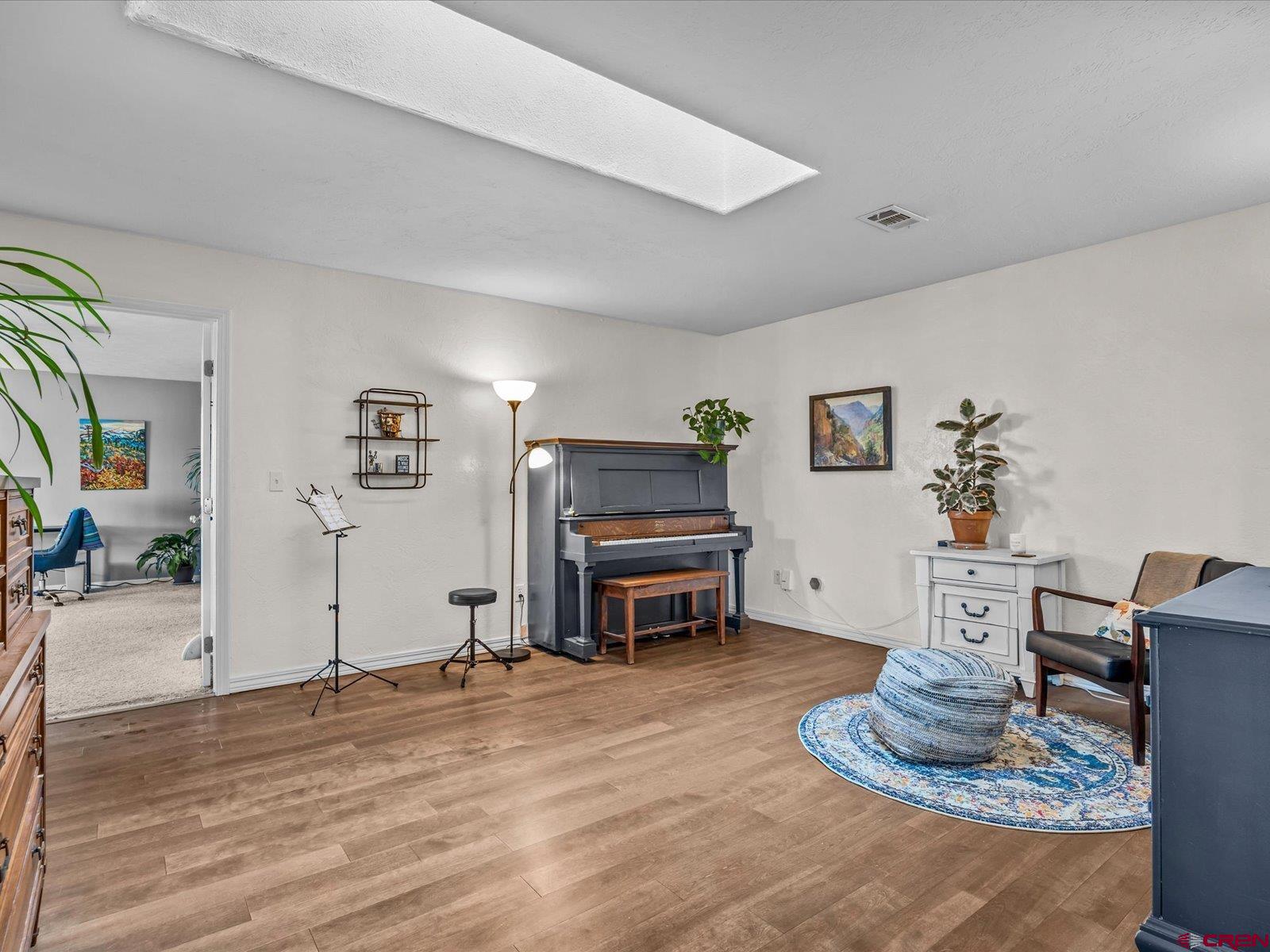 16222 6830th Road Montrose, CO 81401 - Photo 18 of 34 a living room with furniture and wooden floor