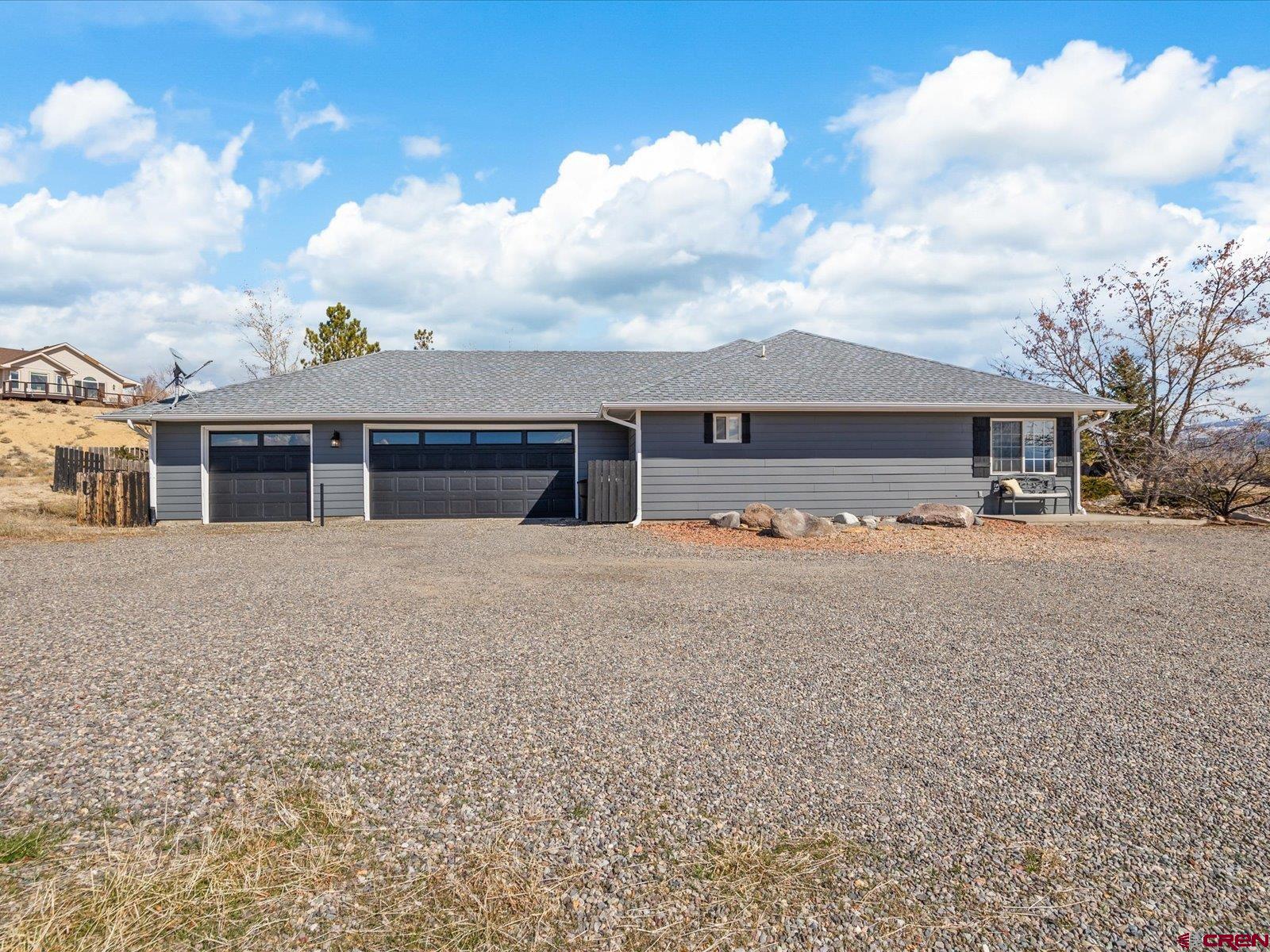 16222 6830th Road Montrose, CO 81401 - Photo 2 of 34 a front view of house with yard and trees in the background